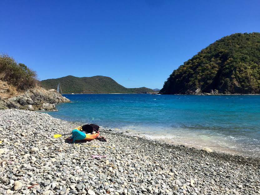 Kayak resting on Whistling Cay's pebble beach. 